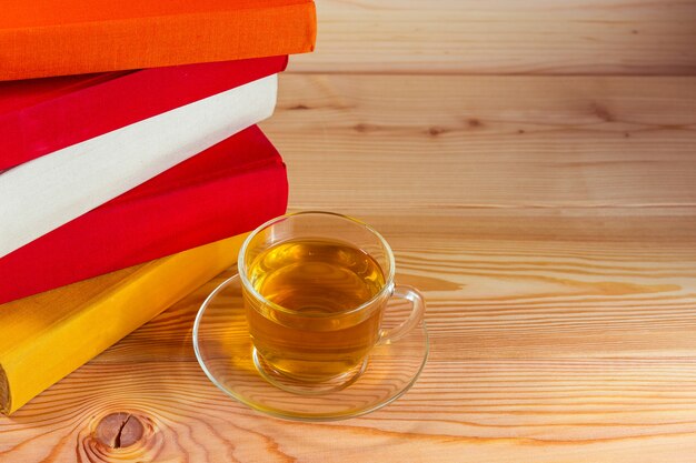 Cup of tea and books onwooden background 