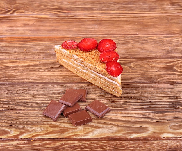 A cup of tea or coffee. Dark Chocolate. Wooden background.