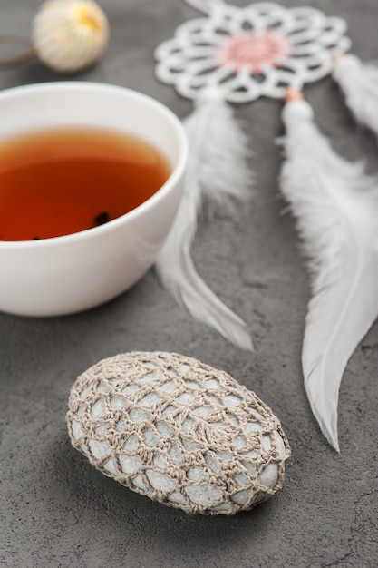 Cup of tea and crocheted pebble