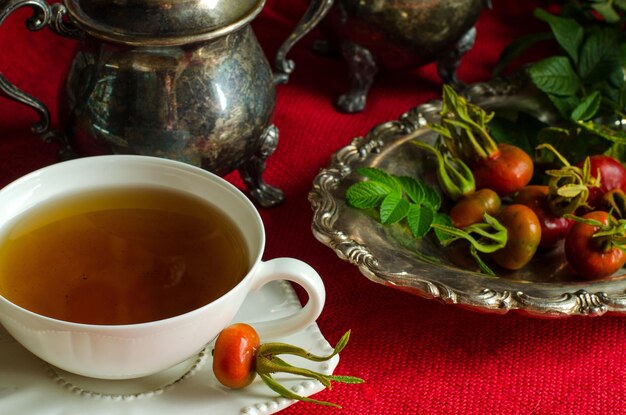 The Cup of tea from the hips White Cup and saucer Herbal decoction The rose hips Vintage silver dish