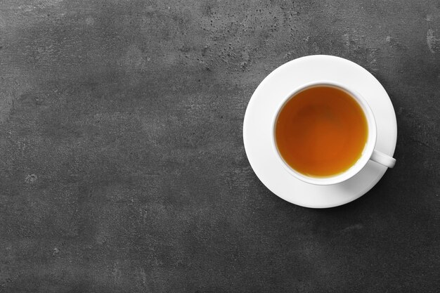 Photo cup of tea on grey background top view