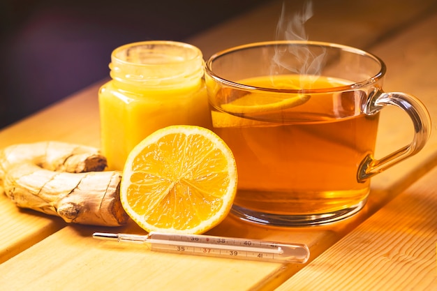 Cup of tea and a jar of honey on a wooden table