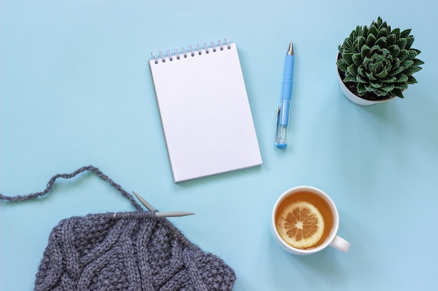 Cup of tea, notepad and pen, succulent and fabric