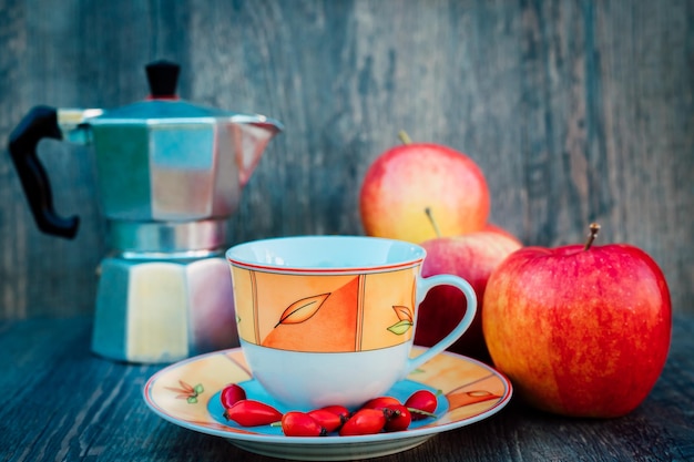 a cup of tea rose hips apples and a kettle vitamins disease prevention