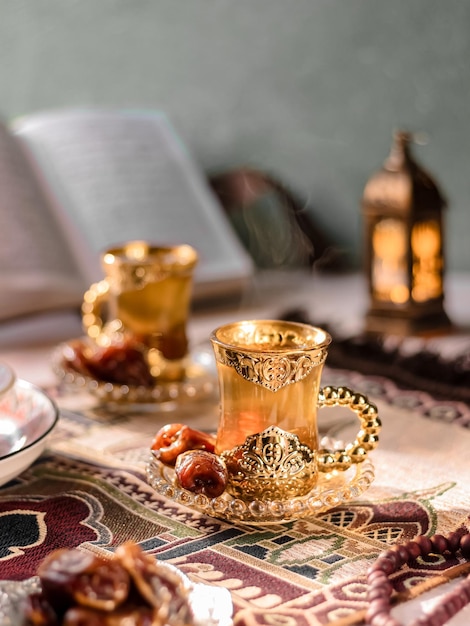 Photo a cup of tea served with dates fruits. middle east vibe concept