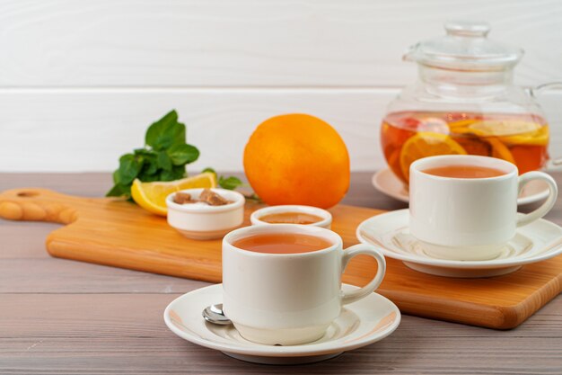 Cup of tea served with lemon and mint