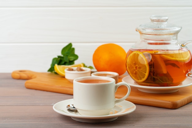 Cup of tea served with lemon and mint