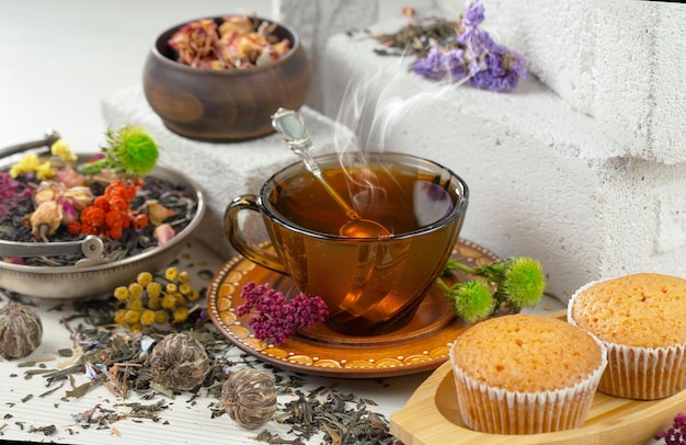 A cup of tea sits on a table next to a cup of tea.