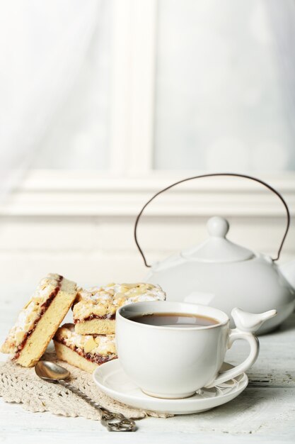 Cup of tea and tasty homemade pie on wooden table