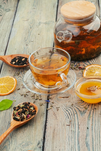 Cup of tea and tea leaves on wooden table