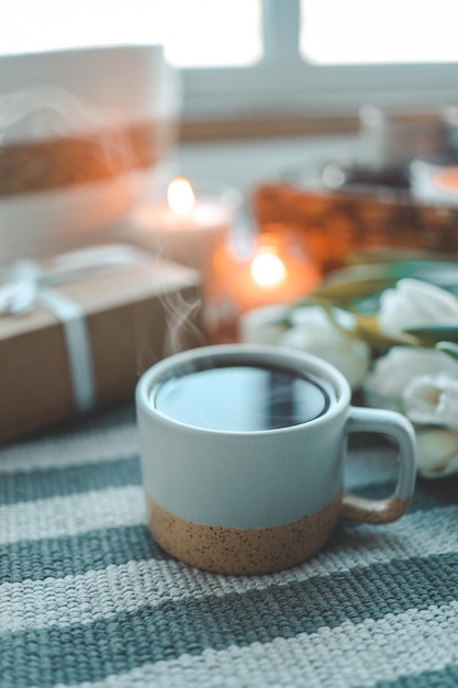 Cup of tea tulips and gift good festive morning