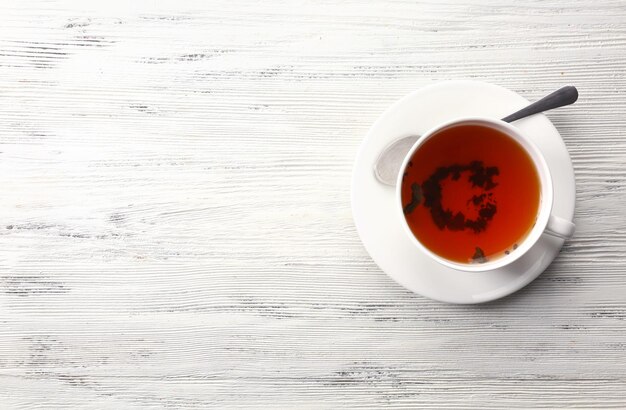 Cup of tea on white table top view