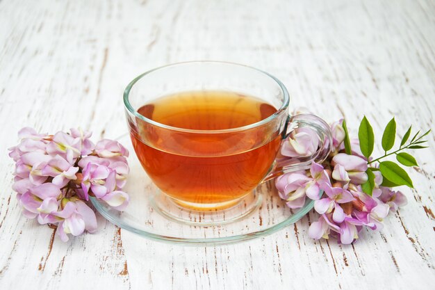 Cup of tea with acacia flowers