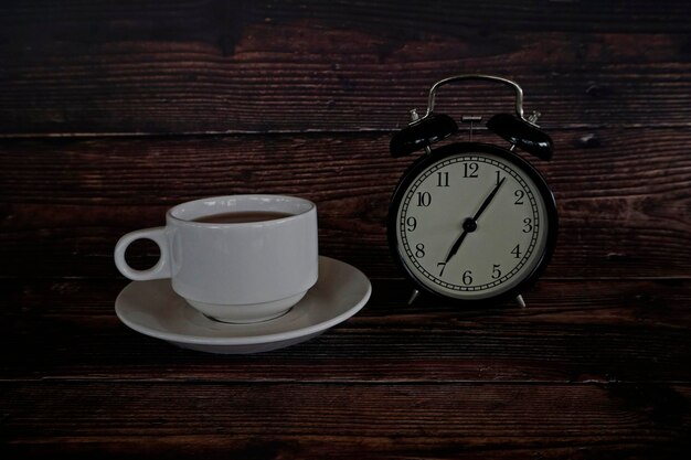 A cup of tea with alarm clock