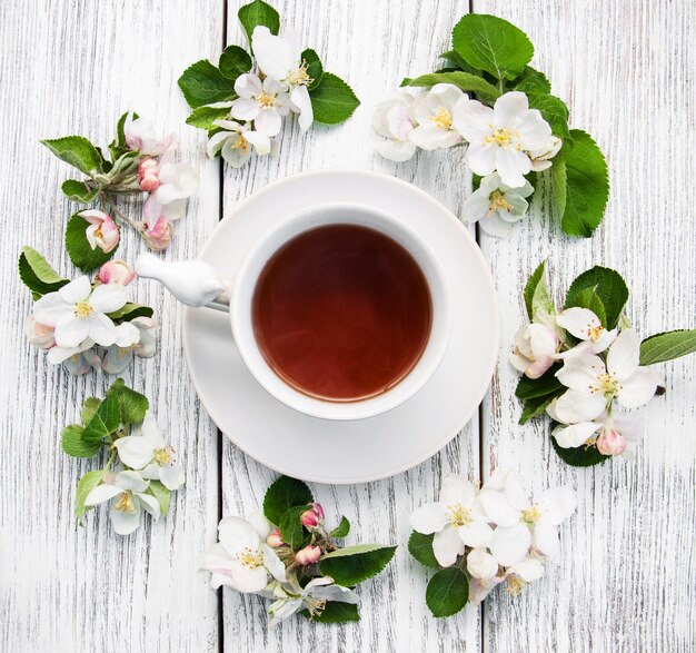 Cup of tea with apple blossoms