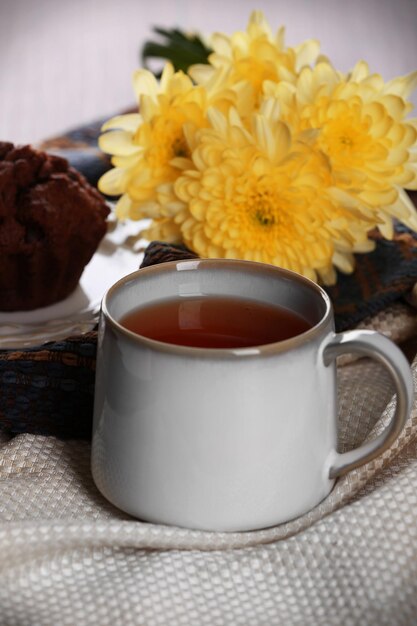 Cup of tea with autumn decor on wooden table