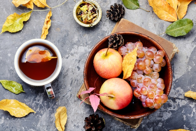 Cup of tea with autumn leaves