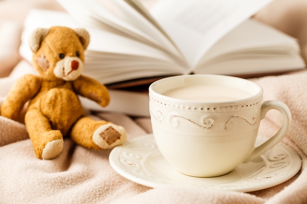 Cup of tea with book on table close-up