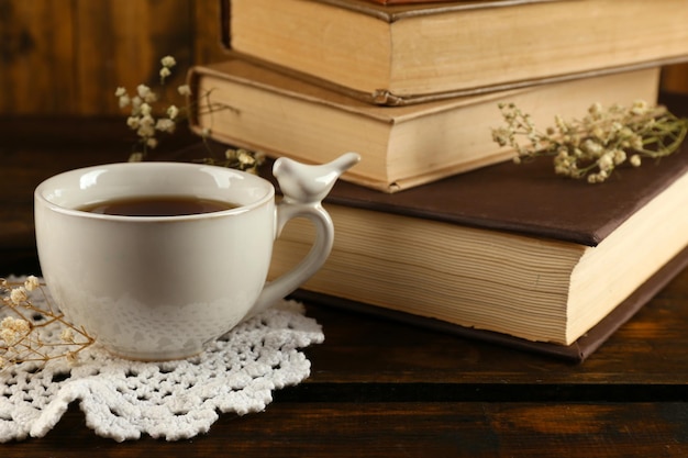 cup of tea with books on wooden background