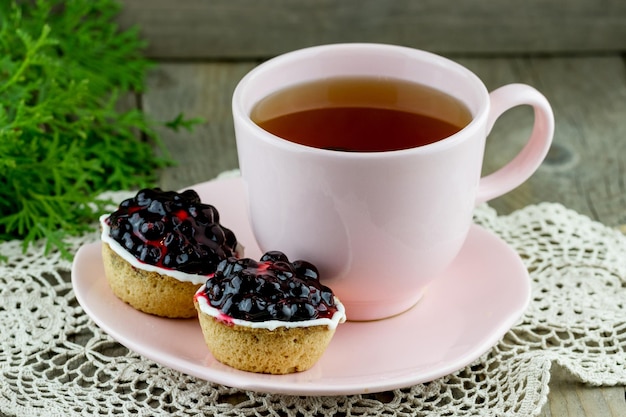 Cup of tea with cakes on a plate