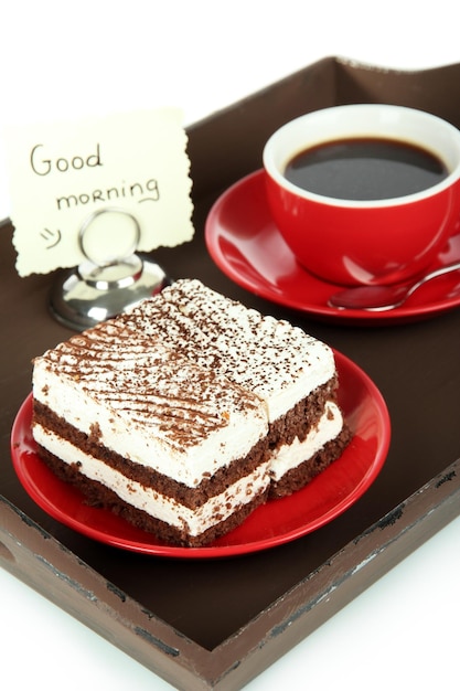 Cup of tea with cakes on wooden tray isolated on white