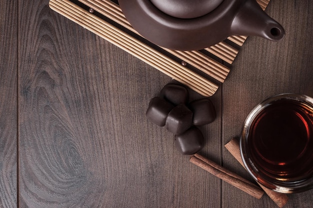 Cup of tea with cinnamon sticks and sweets