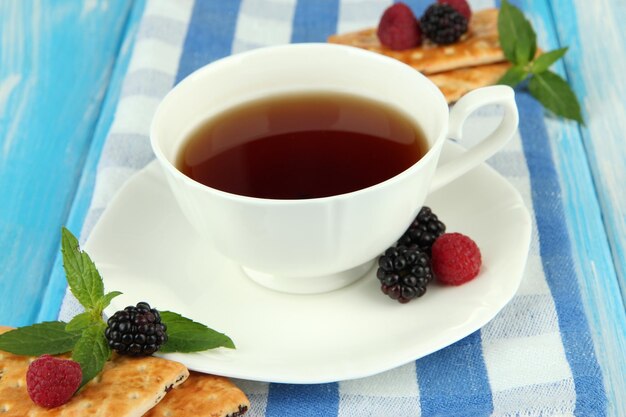テーブルクローズアップでクッキーとベリーでお茶を飲む
