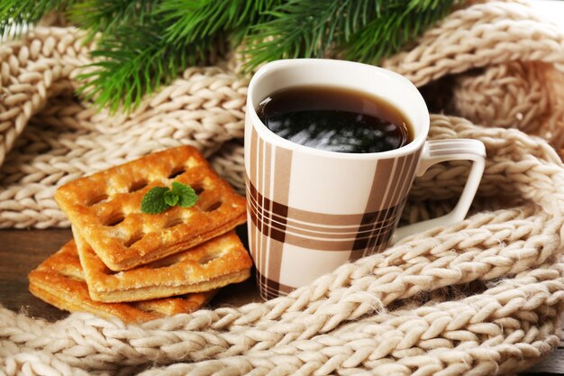 Cup of tea with cookies on table close-up