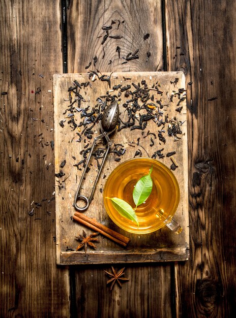 Cup of tea with green leaves