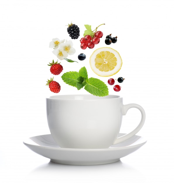 Cup of tea with herbs, fruits and berries