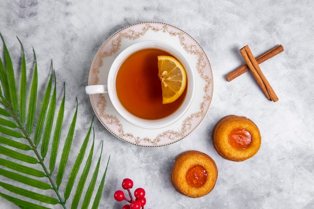 A cup of tea with homemade apricot jam thumbprint cookies.