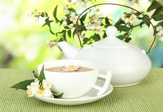 Cup of tea with jasmine, on bamboo mat