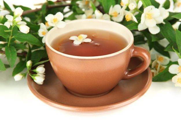 Cup of tea with jasmine isolated on white