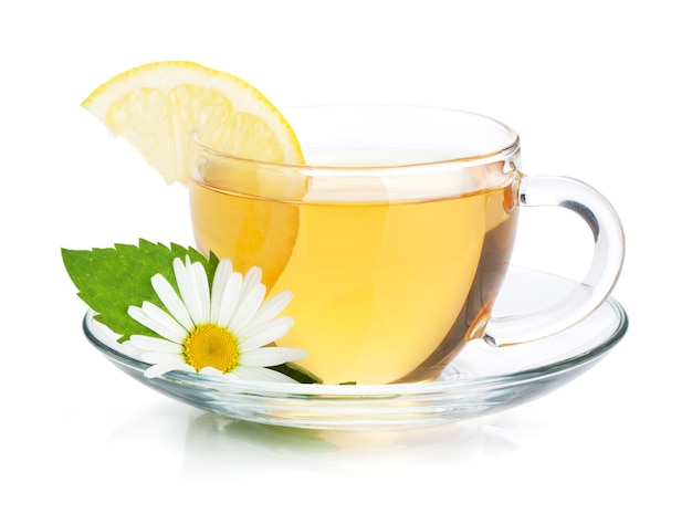 Cup of tea with lemon slice mint leaves and chamomile flower