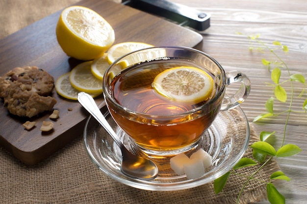 Cup of tea with lemon on wooden table