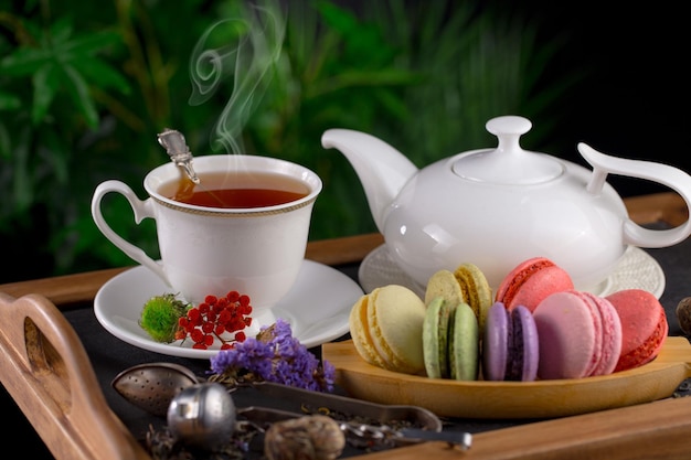 A cup of tea with macaroons and a cup of tea