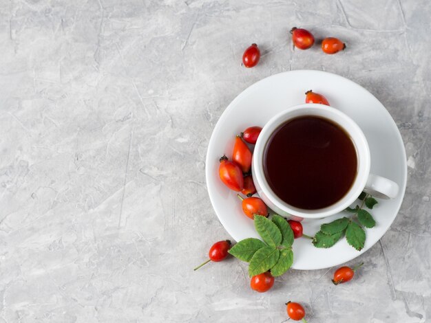 Cup of tea with rosehip berries