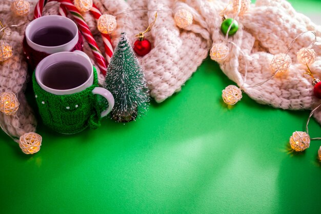 Cup of tea with a scarf on Christmas background