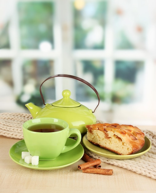 Cup of tea with scarf on table in room