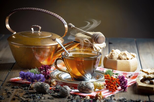 A cup of tea with a spoon and a cup of tea on a table