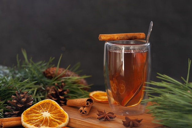 Cup of tea with star anise spices cinnamon sticks and dried oranges