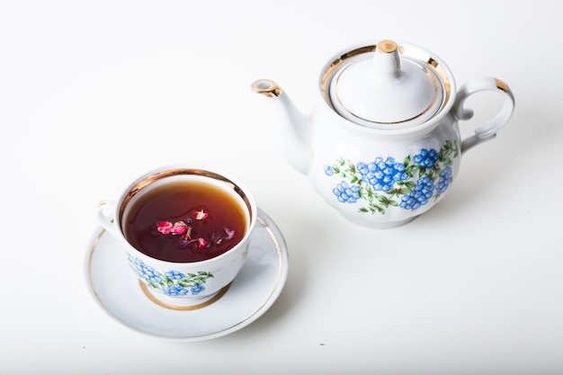 Cup of tea with teapot in vintage style