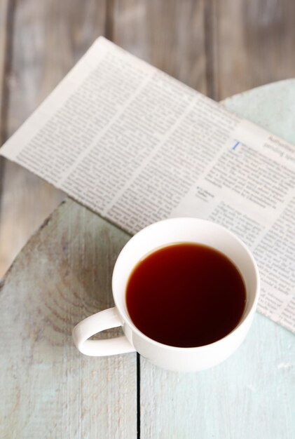 Cup of tea on wooden table outdoors