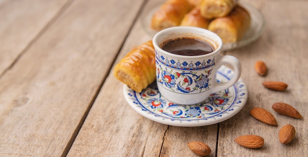 A cup of turkish coffee and baklava.