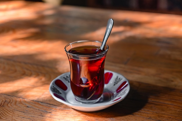 Cup of turkish tea on a wooden table in a cafe