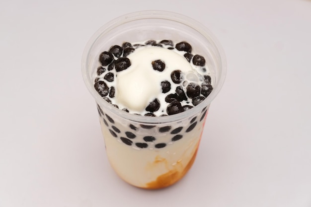 A cup of Vanilla ice cream with boba topping