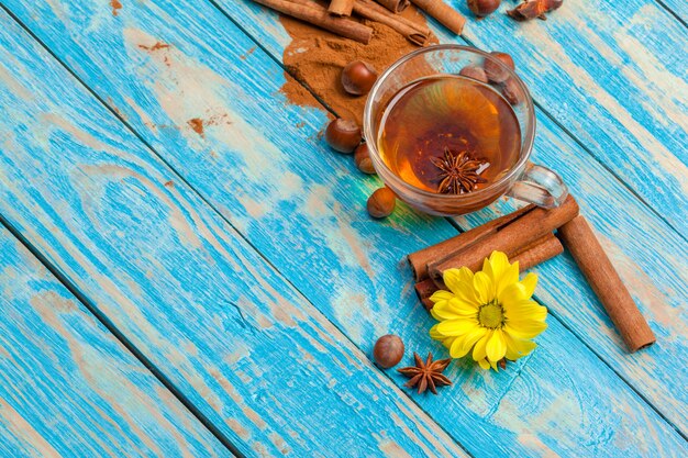 Cup with aromatic hot cinnamon tea on wooden table