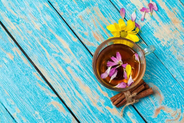 Cup with aromatic hot cinnamon tea on wooden table