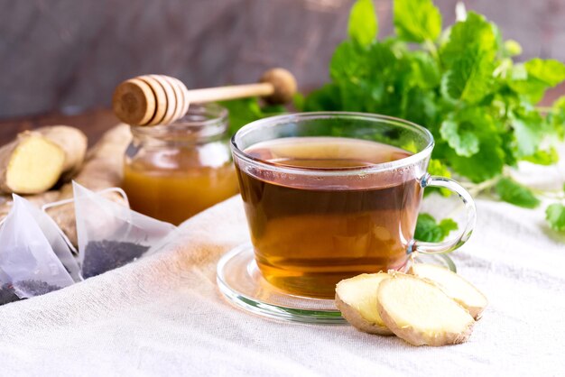 Cup with black tea Fresh mint Honey Ginger