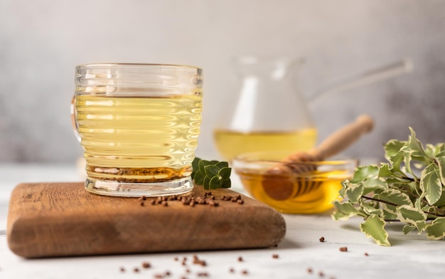 Cup with buckwheat tea granules and honey Superfood Taiwan Ku Qiao buckwheat tea